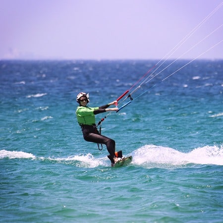 Kitesurf girl riding upwind